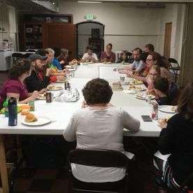 Picture of people sitting around a table eating